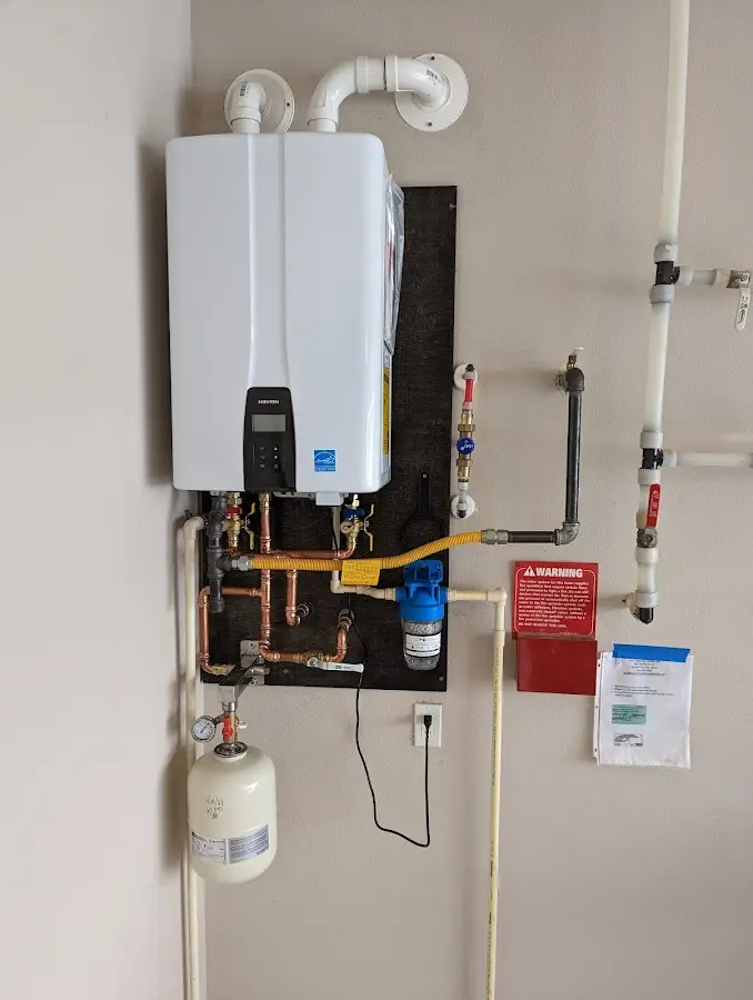 Professional plumber installing copper piping in a Josephine home